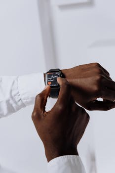 Close-up of a person interacting with a smartwatch for health tracking indoors.