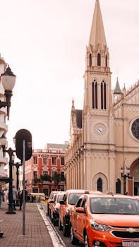 Gothic cathedral and vibrant street in Curitiba, showcasing urban life and architecture.