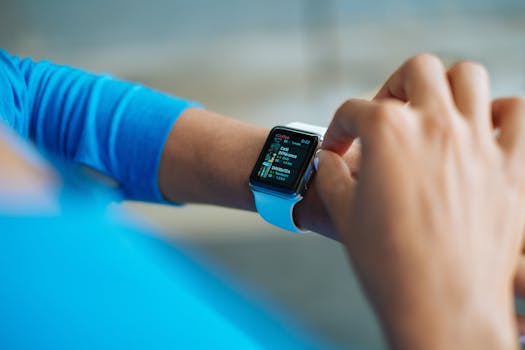 Person interacting with a smartwatch, showing a fitness application on the screen.